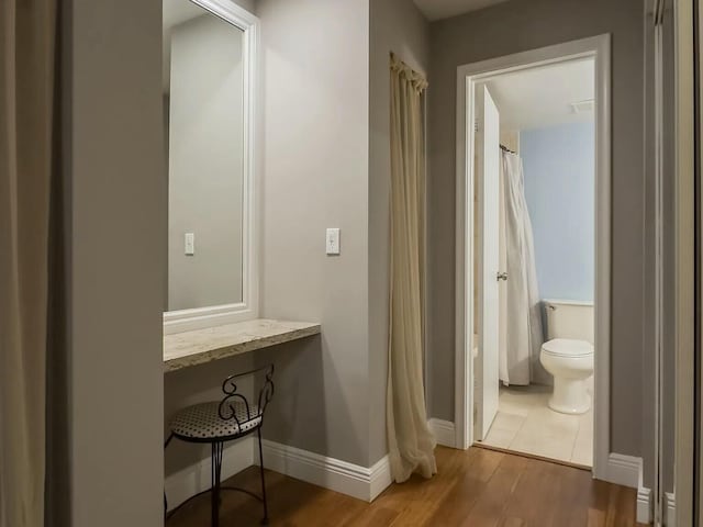 bathroom with hardwood / wood-style flooring and toilet