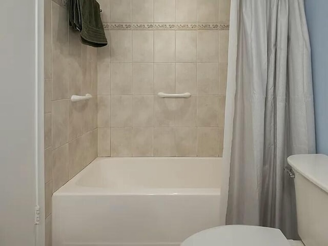 bathroom with shower / tub combo with curtain and toilet