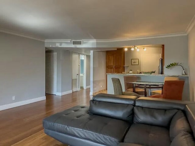 living room with crown molding and wood-type flooring