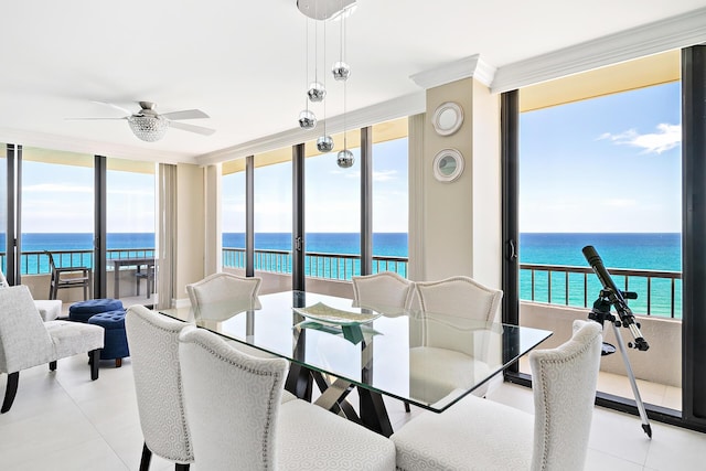 dining room featuring a wealth of natural light, light tile patterned flooring, ceiling fan, and a water view