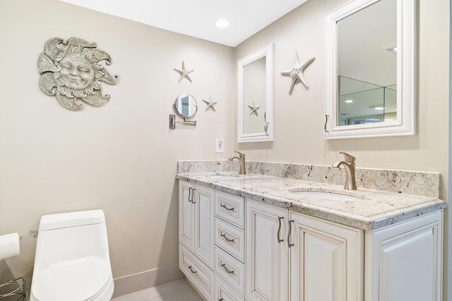 bathroom featuring vanity and toilet