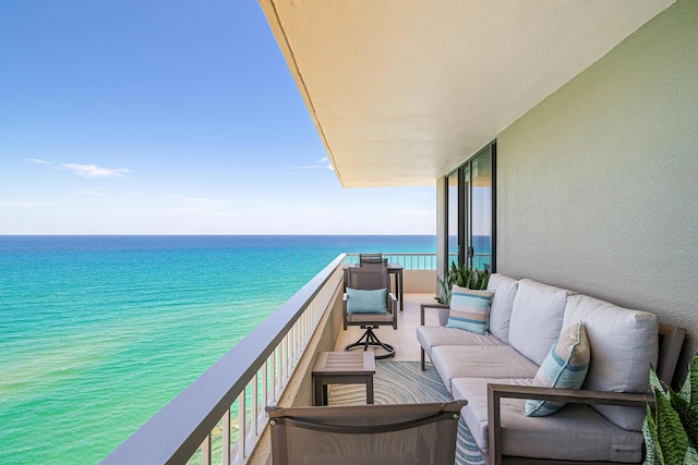 balcony with a water view and an outdoor living space