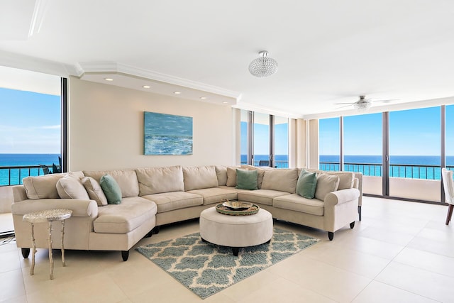 living room featuring expansive windows, ornamental molding, a water view, and light tile patterned floors