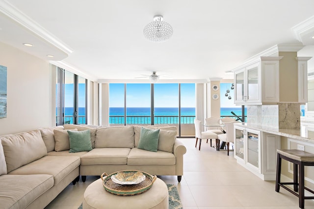 tiled living room with crown molding, a water view, and ceiling fan