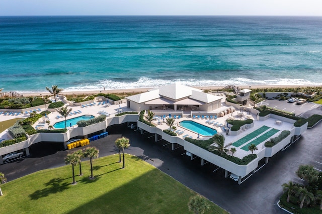 drone / aerial view with a water view and a view of the beach