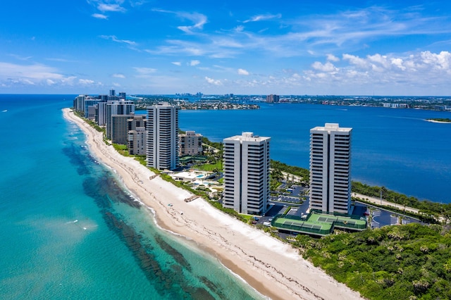 drone / aerial view with a water view and a beach view