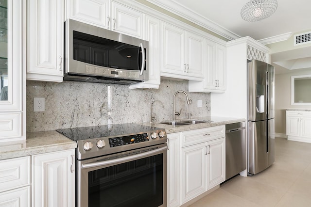 kitchen featuring sink, ornamental molding, stainless steel appliances, light stone countertops, and white cabinets