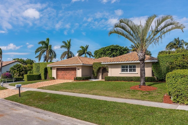 view of front facade featuring a garage and a front lawn