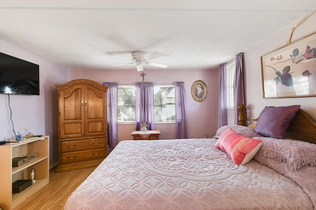 bedroom with ceiling fan and light wood-type flooring