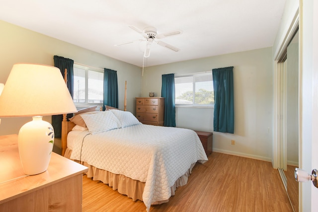 bedroom with a closet, ceiling fan, and light wood-type flooring