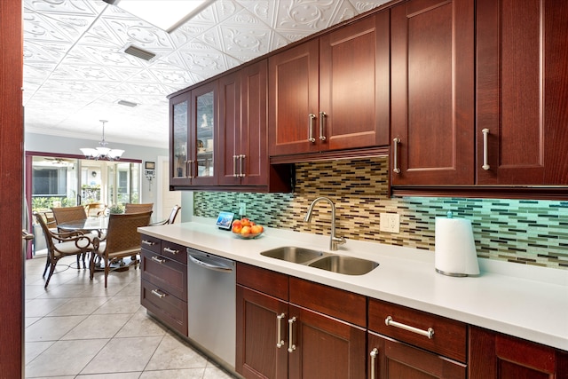 kitchen featuring pendant lighting, sink, decorative backsplash, ornamental molding, and stainless steel dishwasher