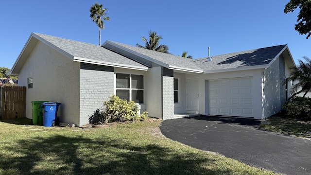 ranch-style house with a garage and a front lawn