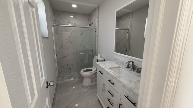 bathroom with vanity, toilet, and an enclosed shower