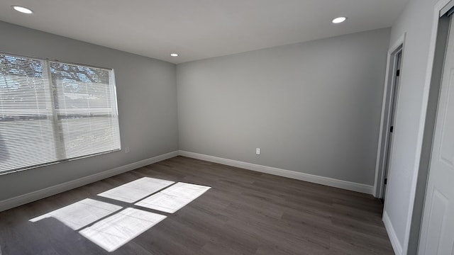 unfurnished room featuring dark hardwood / wood-style flooring