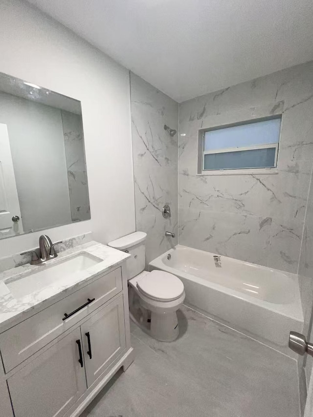 full bathroom with tiled shower / bath combo, vanity, and toilet