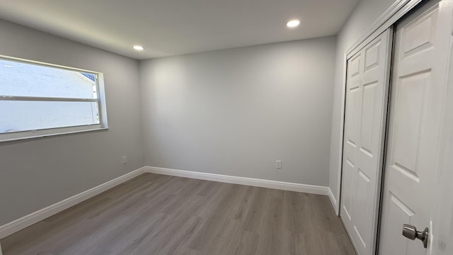 unfurnished bedroom featuring a closet and light hardwood / wood-style flooring