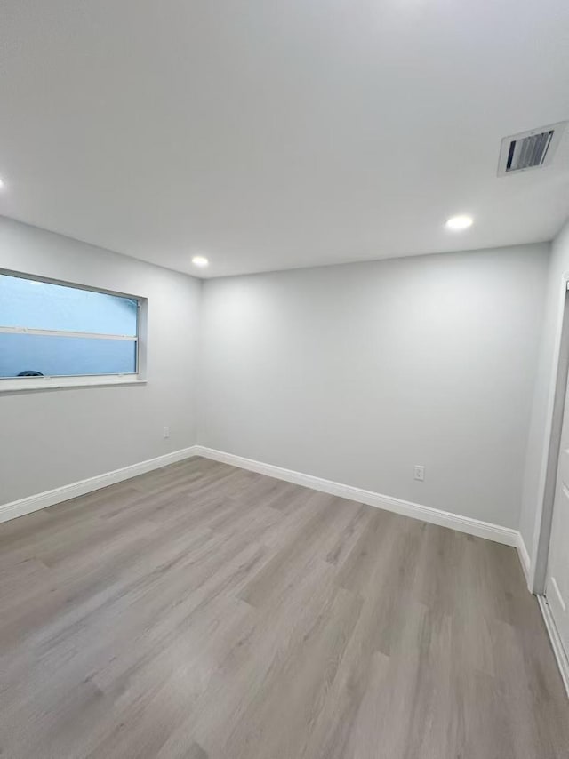 unfurnished room with light hardwood / wood-style floors