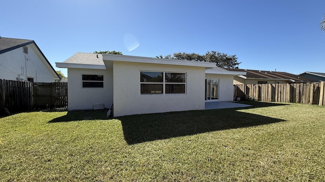 back of house with a lawn