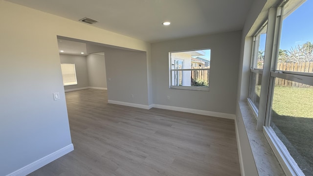 empty room with hardwood / wood-style flooring