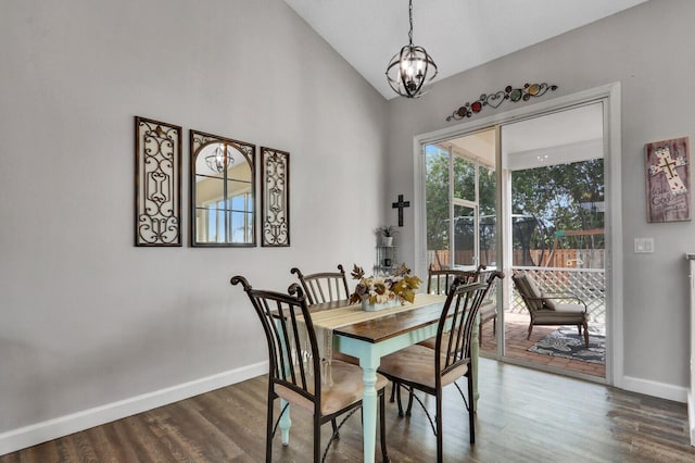 dining space with an inviting chandelier, lofted ceiling, and dark hardwood / wood-style flooring