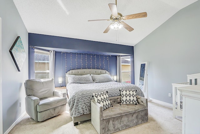 carpeted bedroom featuring multiple windows, a textured ceiling, and ceiling fan