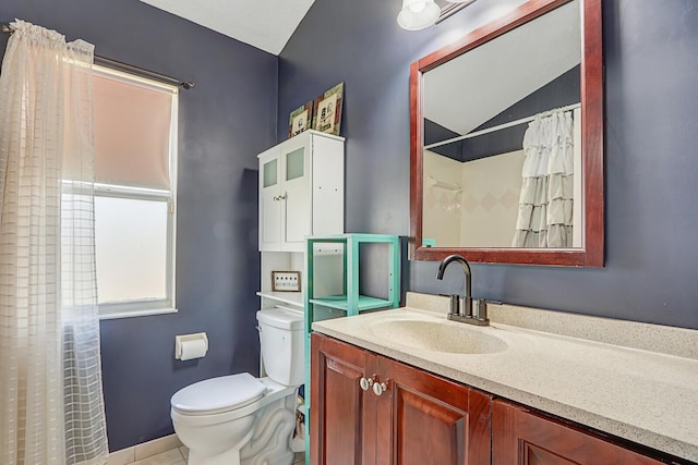 bathroom featuring vanity, vaulted ceiling, and toilet