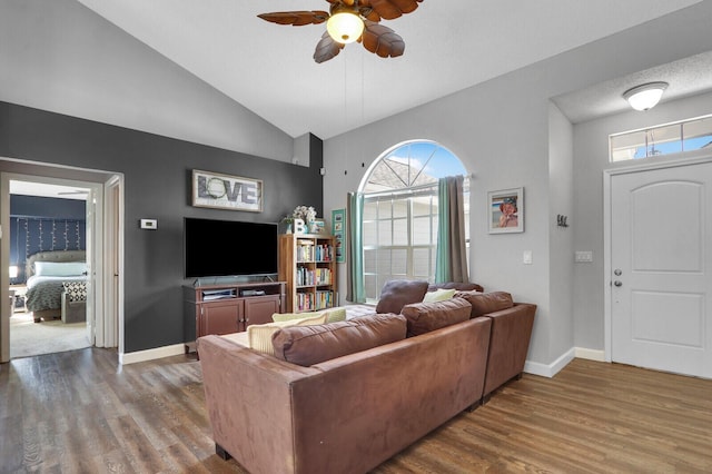 living room featuring hardwood / wood-style flooring, ceiling fan, a healthy amount of sunlight, and vaulted ceiling