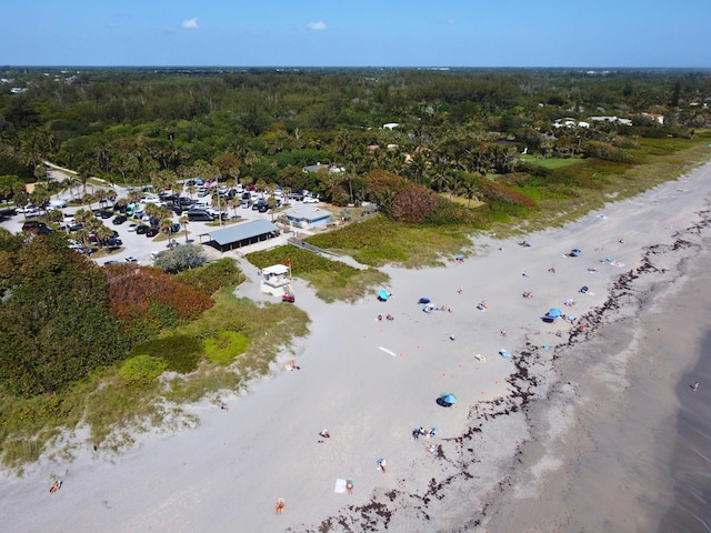 birds eye view of property with a view of the beach and a forest view