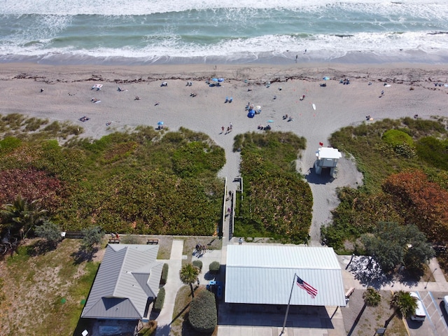 birds eye view of property with a water view and a view of the beach