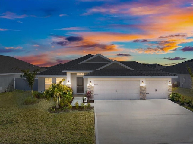 view of front of home with a yard and a garage