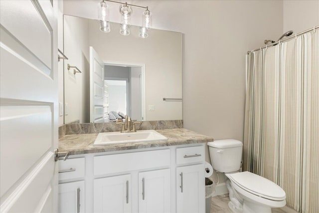 bathroom with vanity, toilet, and curtained shower