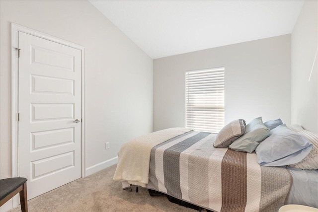 bedroom featuring vaulted ceiling and carpet floors