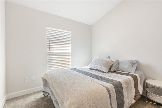 carpeted bedroom featuring vaulted ceiling