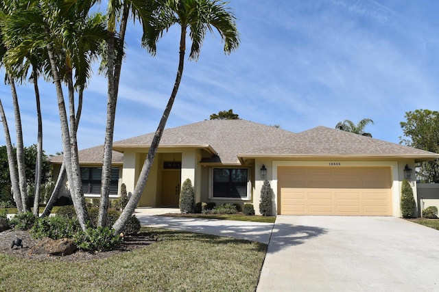 view of front facade with a garage and a front yard