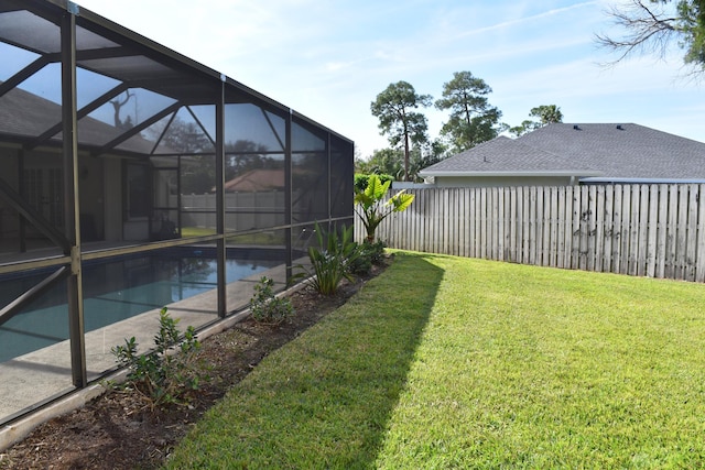 view of yard with a lanai and a fenced in pool