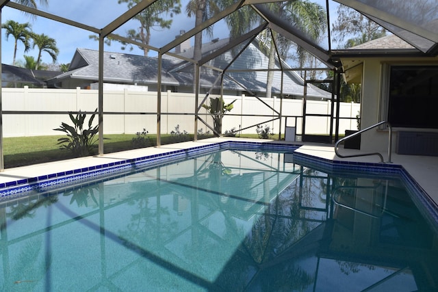 view of pool featuring glass enclosure