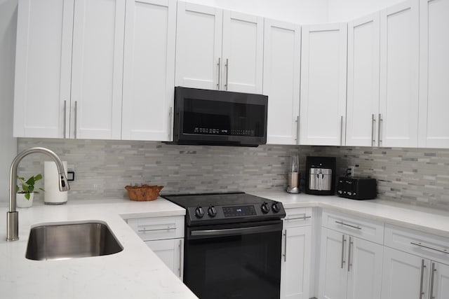 kitchen featuring white cabinetry, sink, and electric range