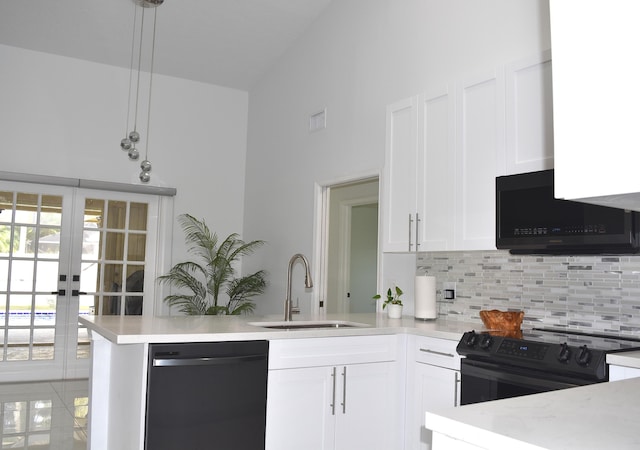 kitchen featuring sink, tasteful backsplash, black appliances, white cabinets, and kitchen peninsula