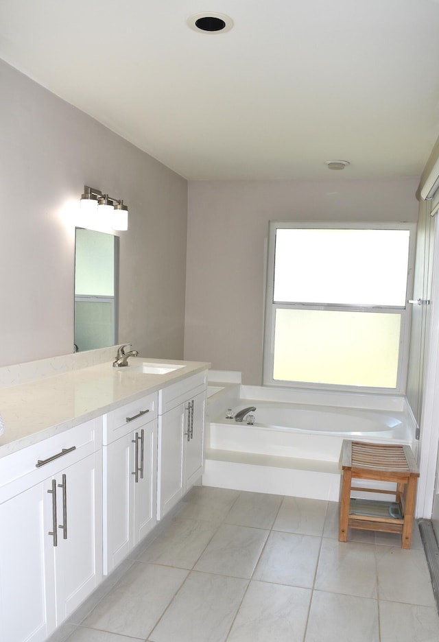 bathroom with vanity, tile patterned flooring, and a bathtub