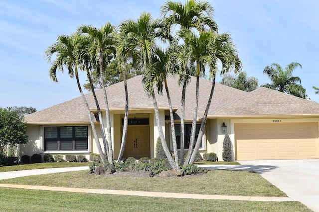 view of front of property featuring a garage and a front yard