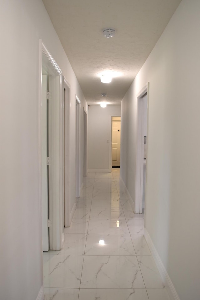 corridor with a textured ceiling