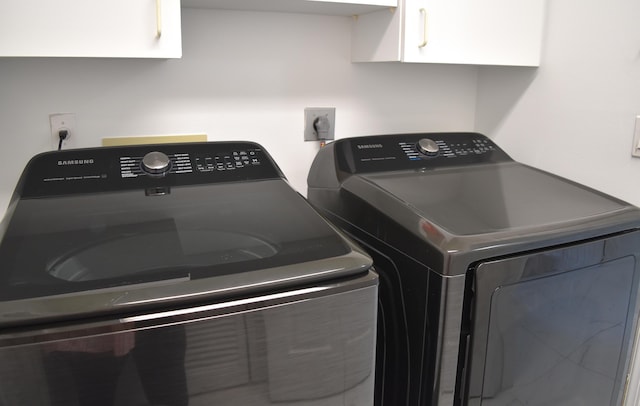 laundry room with cabinets and separate washer and dryer