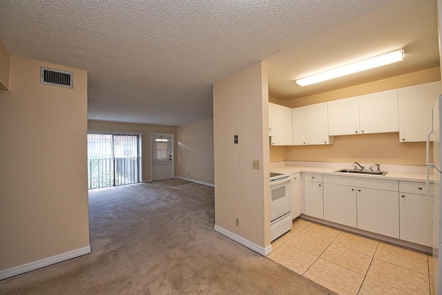 kitchen with sink, white cabinetry, a textured ceiling, electric range, and light colored carpet