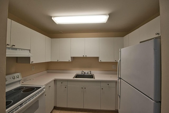 kitchen featuring white cabinetry, sink, light tile patterned flooring, and white appliances