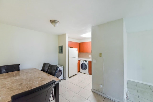 dining space with washer / clothes dryer, light tile patterned floors, and electric panel