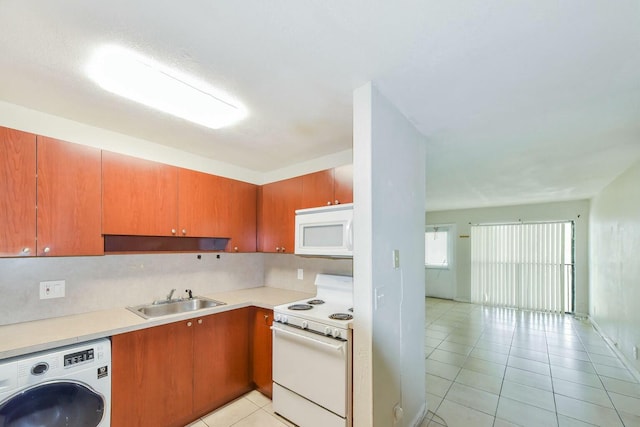 kitchen featuring light tile patterned flooring, sink, white appliances, washer / clothes dryer, and backsplash