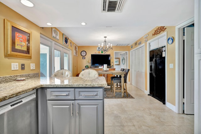 kitchen with gray cabinets, decorative light fixtures, dishwasher, kitchen peninsula, and black fridge