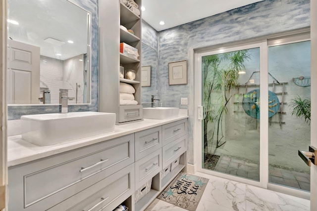 bathroom with vanity and a shower with door