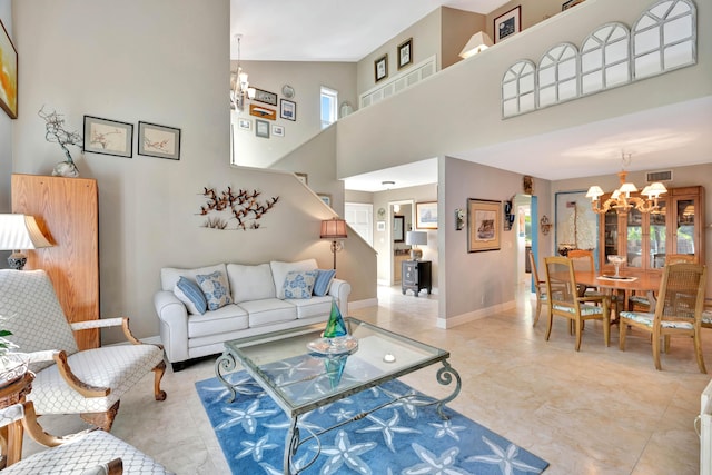 living room featuring a towering ceiling and a chandelier