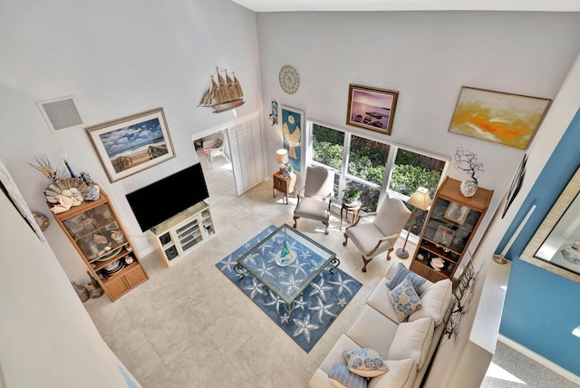 living room featuring carpet flooring and a high ceiling